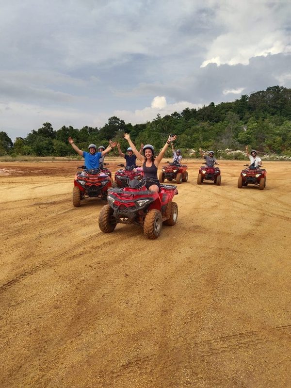 Group on red ATV quads on a sandy trail, Koh Phangan, Thailand
