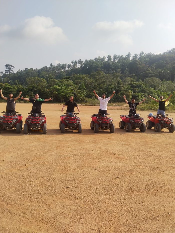 Full ATV tour group standing on their quads before the ride, Koh Phangan